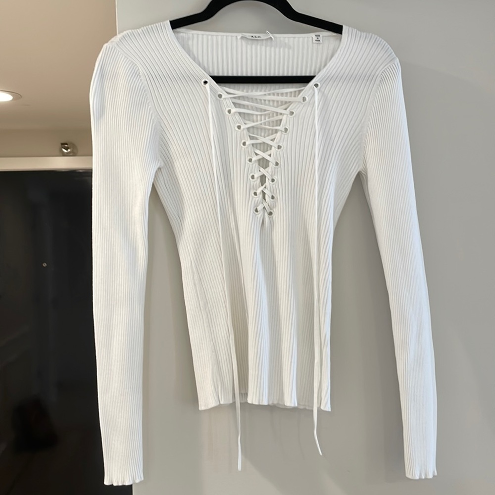 A.L.C. thick white ribbed stretchy top with open crisscross V-neck opening.
